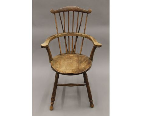 A 20th century comb-back Windsor chair. 60 cm wide. 
