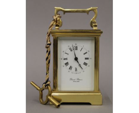 A David Peterson brass-cased carriage clock. 15 cm high.