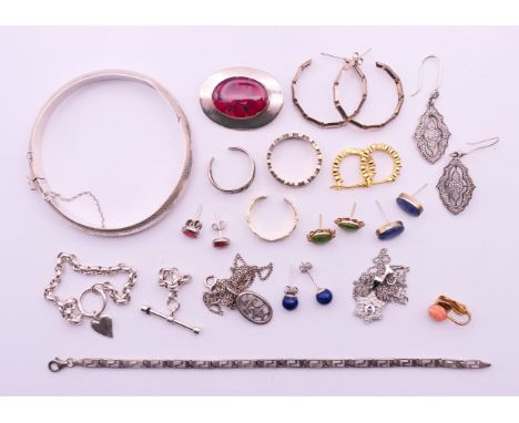 A quantity of silver jewellery, to include: earrings, two pendant necklaces, rings, a bangle, a bracelet and a brooch.  Red f