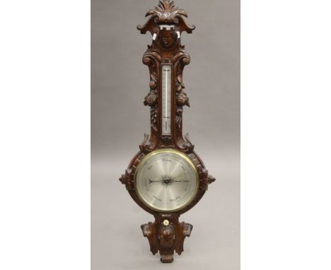 A Victorian carved oak banjo barometer. 113 cm high.