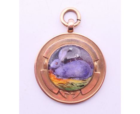 A 9 ct gold and enamel pendant with rabbit, the reverse inscribed '1927 Batley & Dist. Agricultural Society'.  2.5 cm diamete