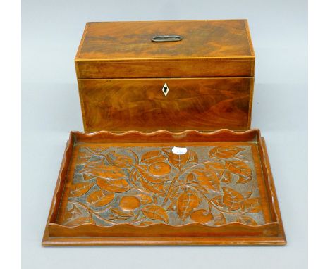 A 19th century mahogany tea caddy and a carved tray. The former 30.5 cm wide.
