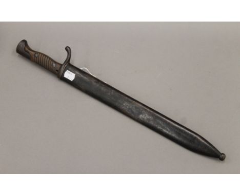 A German Waffenfabrik Mauser A G bayonet in scabbard. 51.5 cm long.