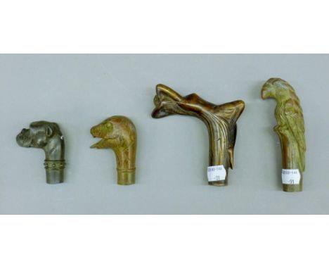 Four bronze walking stick handles. The largest 12.5 cm high.