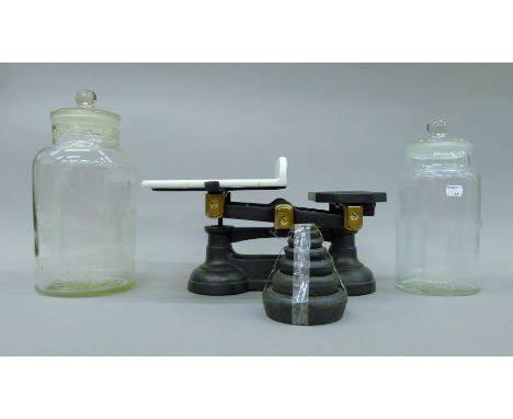 A set of Victorian scales and weights and two glass jars. The former 38 cm long.