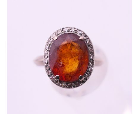 An 18 K white gold citrine and diamond ring.  