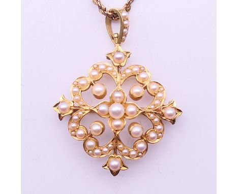 An unmarked gold and seed pearl pendant on a 10 K gold chain.  Pendant 3.5 cm high including suspension loop, chain 45 cm lon