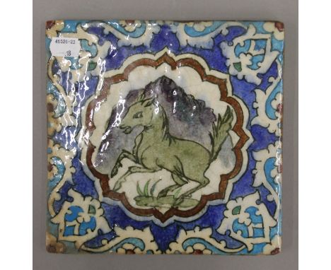A 19th century Iznik porcelain tile decorated with a horse. 20 x 20 cm.