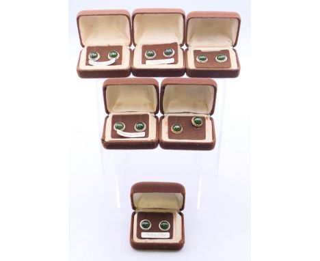 Five pairs of silver earrings with central green stone, and one pair of 10 K gold back earrings.  Each 1.25 cm diameter. 