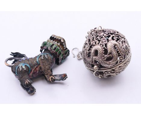 A 19th century Chinese silver and enamelled temple lion and a small spherical censer on a suspension chain.  Temple lion 6 cm