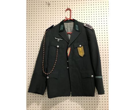 A COLLECTION OF FOREIGN ARMY AND SIMILAR UNIFORMS. A collection of uniforms including a khaki jacket with Royal Marines Butto