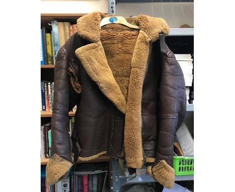 A LEATHER AND SHEEPSKIN FLYING JACKET. An Irvin type flying jacket, probably RAF World War II or post war. With damage to rig