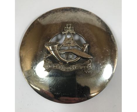 A 10TH GURKHA RIFLES BADGE. A 10th Gurkha Rifles Pipers sash badge, a broad circular disc centred by a suspended bugle and ku
