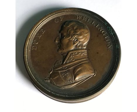 A DUKE OF WELLINGTON'S VICTORIES MEDAL/BOX CONTAINING PAPER DISKS. A two part circular box, the lid with bust length portrait