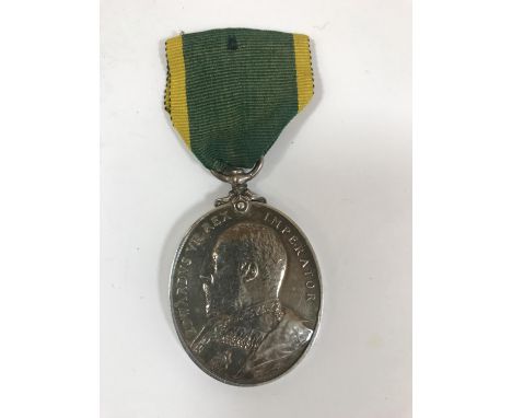 A TERRITORIAL FORCE EFFICIENCY MEDAL. An Edward VII Territorial Force Efficiency Medal named to 69 Private W. Kidwell, 6/Devo