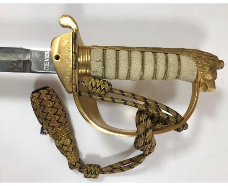 A NAVAL OFFICER'S SWORD BY GIEVES. An Elizabeth II Naval Officers Sword by Gieves of London. The 78cm pointed blade etched to