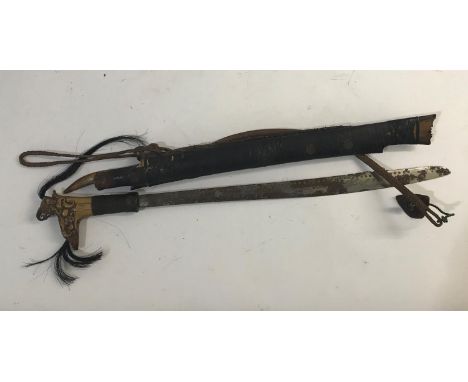 BORNEO HEAD HUNTERS SWORD AND SCABBARD. An unusual Head Hunters Sword (mandau) with elaborate carved bone hilt from which is 