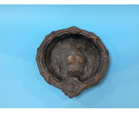 A heavy brass lion mask door knocker, 25cm diameter