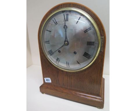 A late 19th century oak case bracket clock with quarter chiming and hour strike on five gongs with silvered dial 