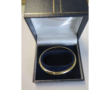 An 18ct hallmarked diamond hinged bangle 6cm x 6.5cm external, approx weight 14 grams - generally good, small usage 