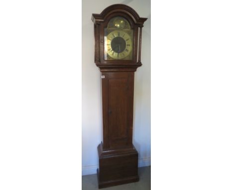 An oak three train chiming longcase clock with a brass arched 12inch dial signed John Simpson, London - runs but strike needs