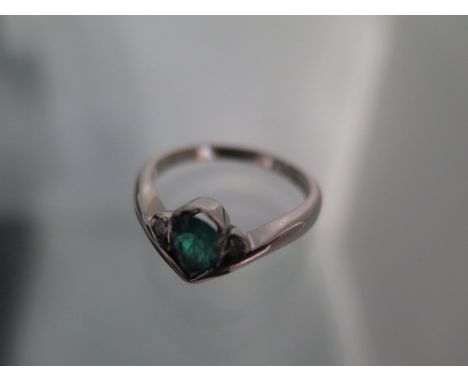 An 18ct white gold pear shape emerald and diamond ring, emerald is a good colour and has natural inclusions, ring size approx