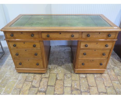 A Victorian light oak nine drawer twin pedestal desk with a leather inset top  small moulding loss  - Height 72cm x 137cm x 6