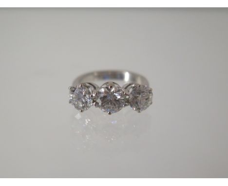 An 18ct white gold three stone ring - the centre diamond approx 1.20ct flanked by approx 1.00ct diamonds each side - ring siz