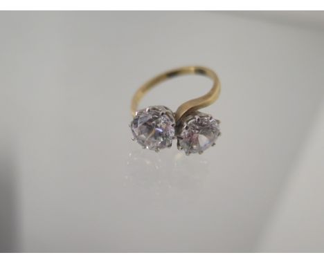 A 9ct yellow gold crossover CZ ring each approx 8mm diameter - ring size O - approx weight 4.7grams 