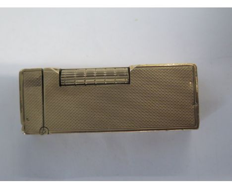A 9ct yellow gold Dunhill gas lighter - Height 6.5cm - approx weight 101 grams - some dents and wear, will need some restorat