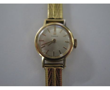 An 18ct yellow gold Tissot ladies manual wind watch on 18ct gold strap - 17mm case, approx weight 20 grams - running, no box 