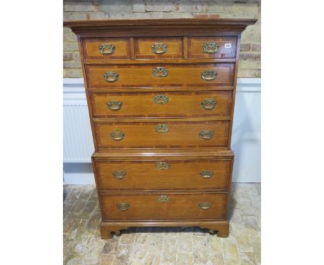 A Georgian style oak chest on chest with crossbanded and inlaid drawers, three small over five long graduating drawers on sha