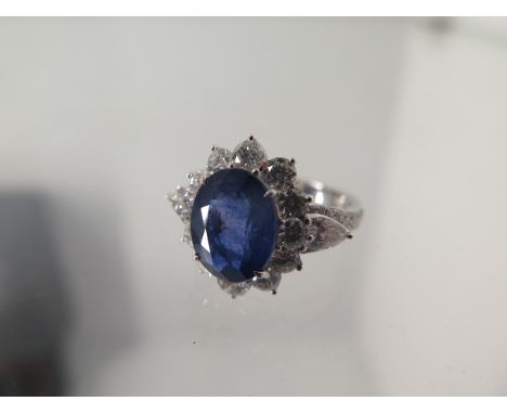 An 18ct white gold sapphire and diamond ring - sapphire approx 4.25ct, diamonds approx 2ct - ring size N/O - head size approx