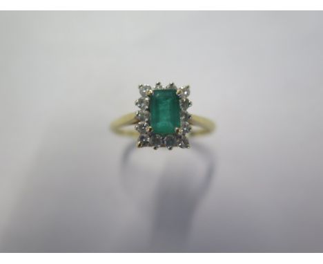 A hallmarked 18ct yellow gold Emerald and diamond ring size P, head approx 9.7mm x 8.6mm - approx weight 3.2 grams - generall