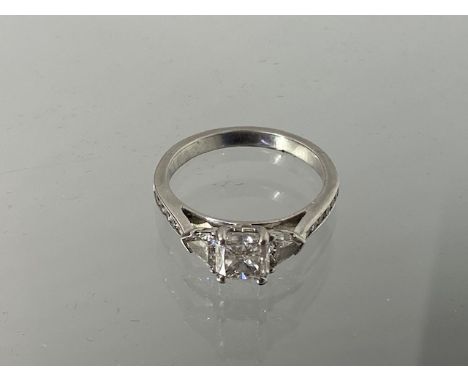 A good quality 950 platinum three stone diamond ring with a central cushion cut diamond, carat weight 1.20ct, colour F, clari