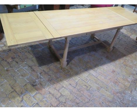 A Neptune light oak draw leaf refectory style dining table on turned supports - Height 75cm x Width 89cm - extends from 173cm