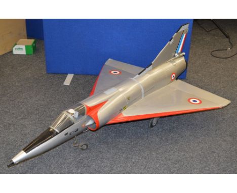 A large jet powered fighter plane model, possibly a Mirage. Fiberglass construction with servos and engine. No control pad.