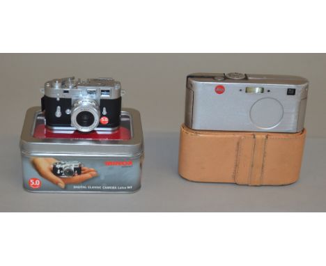 2 Leica cameras: M3 Minox in tin with accessories together with a Leica D-Lux in leather case (2)