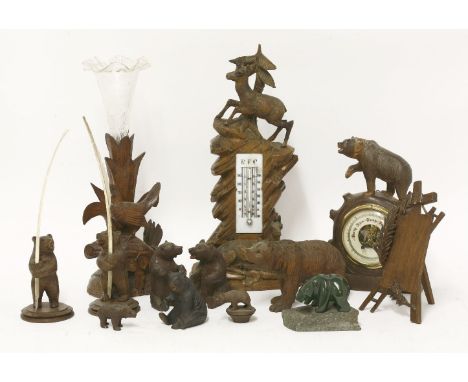 A collection of Black Forest bears,including a barometer,eight small bears,a desk thermometer with two deer, 35cm high,a wood