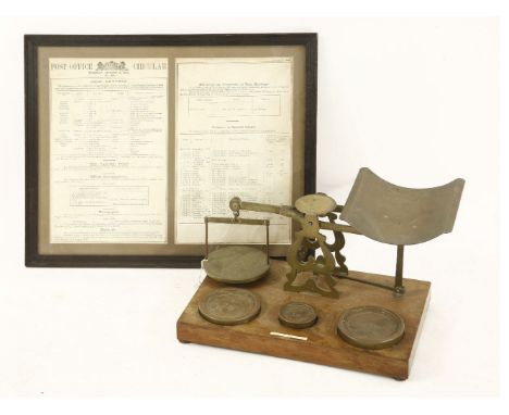 A large set of Victorian brass postal scales,on a wooden base, inscribed 'Houghton & Gunn, 162 New Bond St.' and 'S Mordan & 