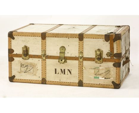 A wardrobe steamer trunk,upright drawers and a case, in cream with faux wood grained mounts