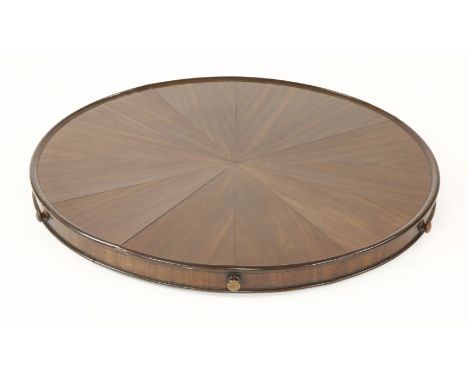 A mahogany lazy Susan,by John Earnshaw, early 19th century, the circular top with segmental veneers, the frieze with six turn