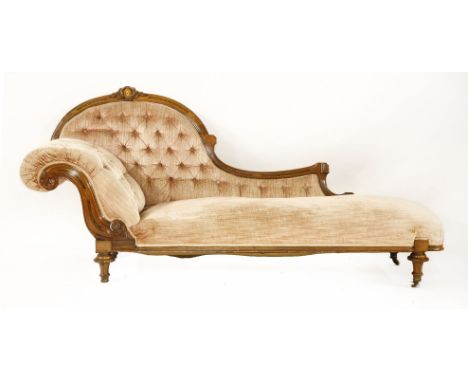 A late Victorian walnut salon suite,consisting of: a chaise longue, an open armchair, a nursing chair and six balloon back di