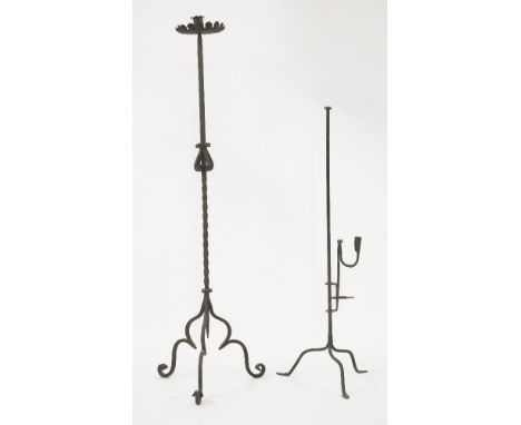 An iron candlestand,with wide scalloped drip pan, scroll and twisted work, on four shaped legs, 136cm high,together with an a