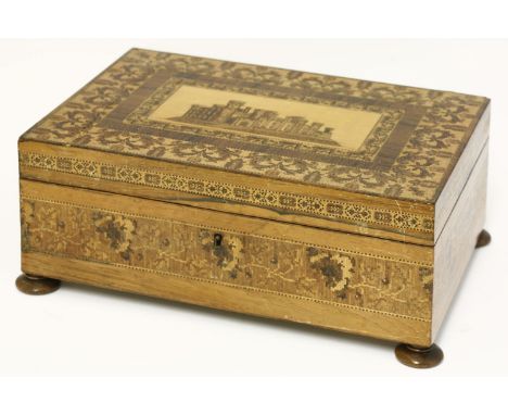 A Tunbridge ware workbox, the lid with a tessellated castle, within floral borders, the lift-out tray with a tessellated comp