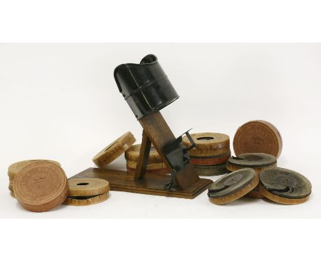'The Kinora' reel viewer,mounted on an oak hinged stand, with a black view finder, with sixteen reels:Punting on the Thames (