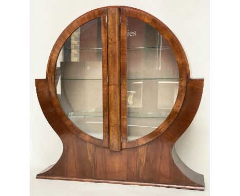 'CIRCULAR' ART DECO DISPLAY CABINET, circa 1930 figured walnut of circular form with two glazed panelled doors enclosing shel