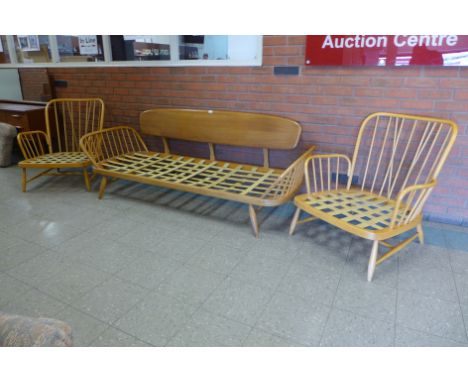 An Ercol Blonde elm and beech 355 model studio couch and pair of matching armchairs 
