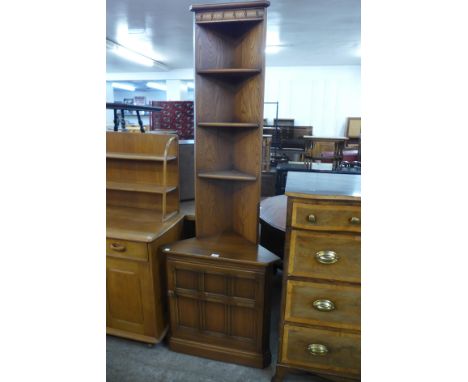 An Ercol Golden Dawn elm and beech freestanding corner cabinet 
