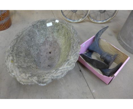 A concrete garden planter and cobbler's lasts 